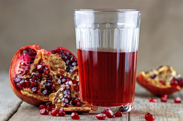 Pomegranate slices and a glass of juice on the table