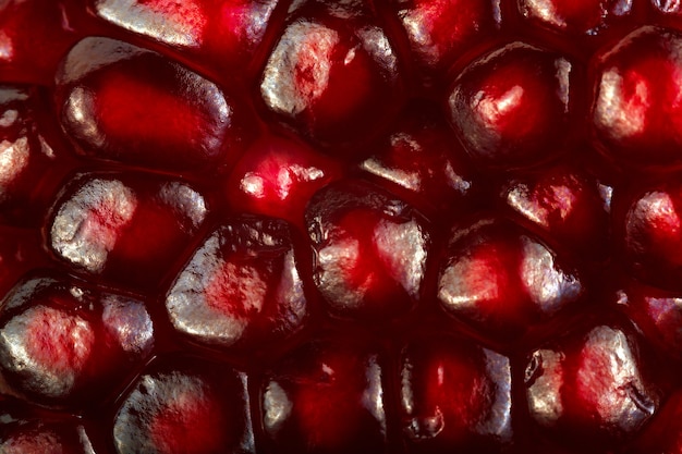 Pomegranate with ripe grains on a white background.