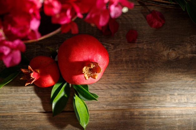 Pomegranates on a wooden table the symbol of the Jewish new year Rosh Hashanah Dark background