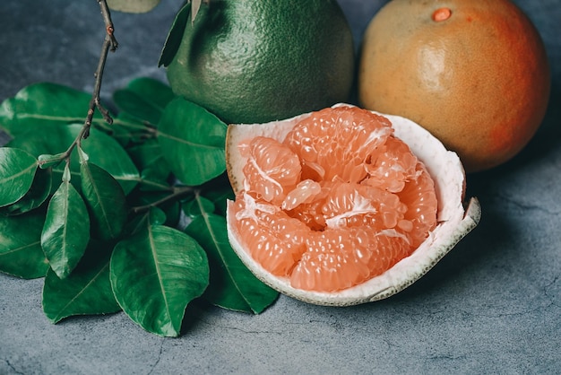 pomelo fruit on dark background fresh pomelo peeled on pomelo skin and green leaf frome pomelo tree pummelo grapefruit in summer tropical fruit in thailand