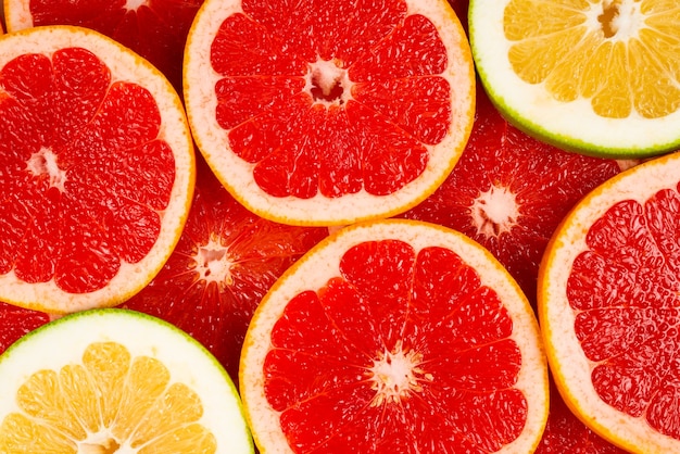 Pomelo and grapefruit juicy slices background.