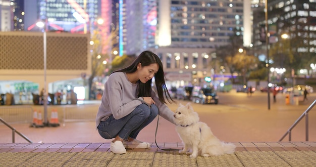 Pomeranian with owner and standing at outdoor