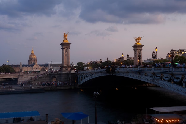 Pont Alexandre III Bridge at sunset with view of the Invalides Paris France