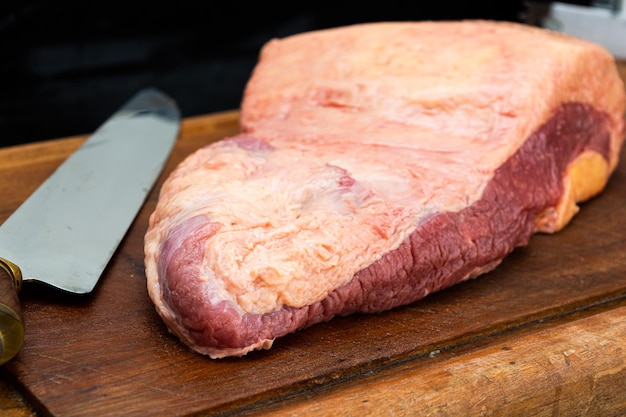 ponta de peito or brisket raw for barbecue over wooden table