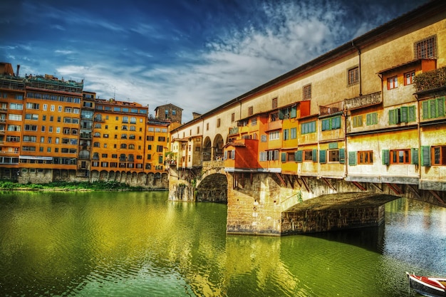 Ponte Vecchio seen from Arno bank in Florence Italy