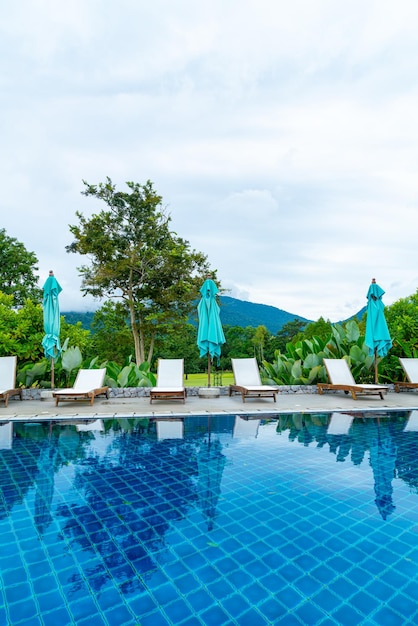 Pool bed around swimming pool with mountain hill background