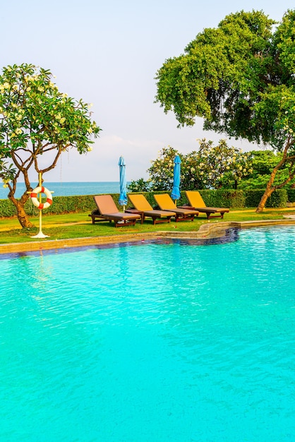 Pool beds and umbrellas around swimming pool