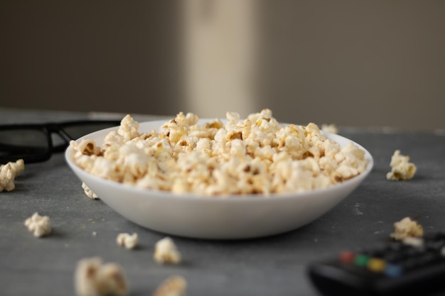 Pop corn bowl viewed from above on a blue background. Top view