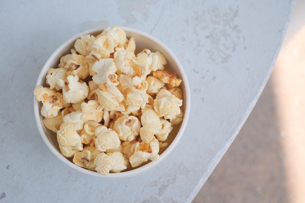 Popcorn in a bowl on wooden desk