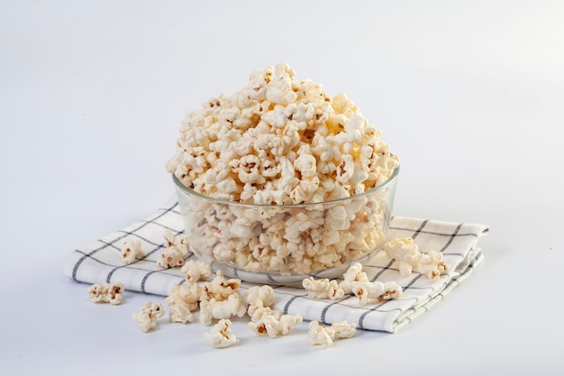 Popcorn in brown bowl on white background