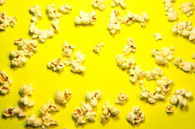 Popcorn flakes scattered on yellow