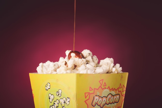 Popcorn isolated in red background