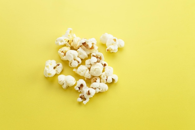 Popcorn a kind of savory snack from corn seed Isolated on yellow background selected focus