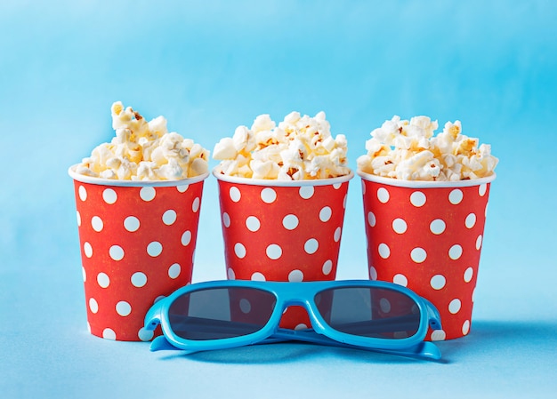 Popcorn with 3d glasses on blue background