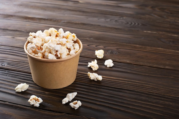 Popped corn snack in paper bucket on kitchen table