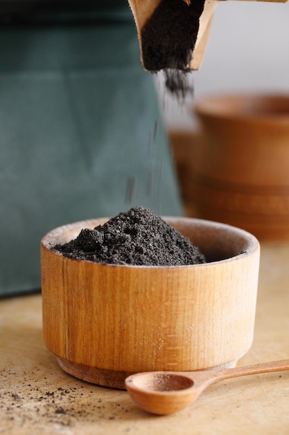 Poppy seeds with poppy flour on wooden table Coeliac disease concept