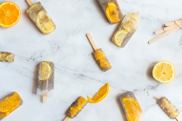 Photo popsicle of orange and lemon with chia