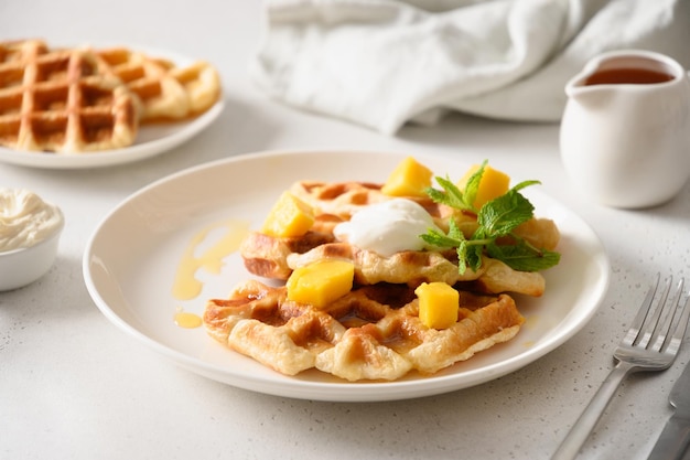 Popular croffles with maple syrup and whipped cream for delicious breakfast Croissant as waffle