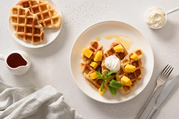 Popular croffles with maple syrup and whipped cream for delicious breakfast Croissant as waffle