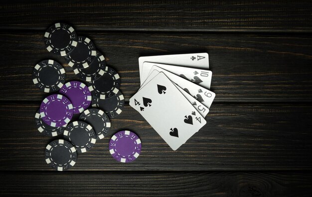 A popular poker game with a winning combination of high card Cards with chips on a black vintage table in a poker club