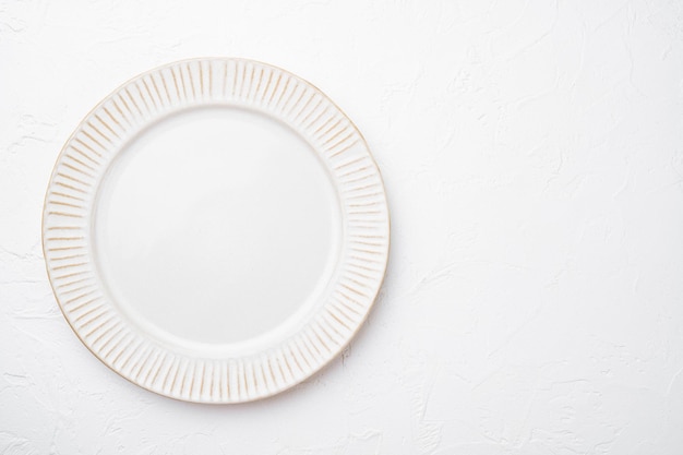 Porcelain empty white plate set with copy space for text or food with copy space for text or food, top view flat lay, on white stone table background