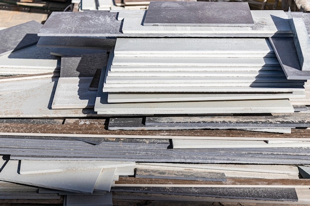 Porcelain stoneware tiles on a pallet at a construction site. Remains of tiles after laying the floor.