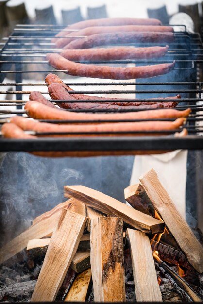 Photo pork and beef sausages being grilled