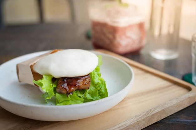 Pork bun on wood table in cafe