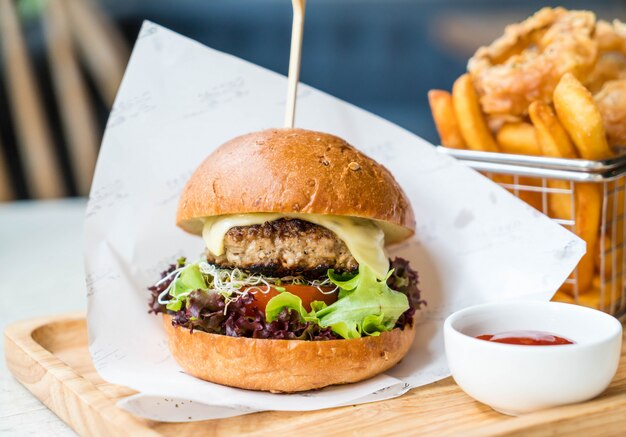 pork burger with onion rings and french fries