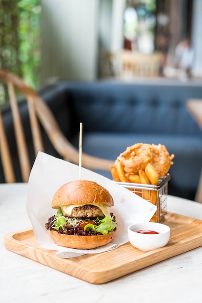 pork burger with onion rings and french fries