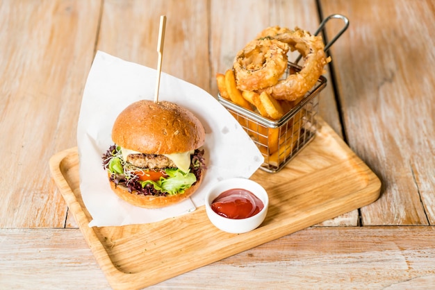 pork burger with onion rings and french fries