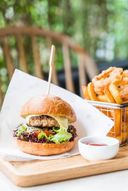 pork burger with onion rings and french fries