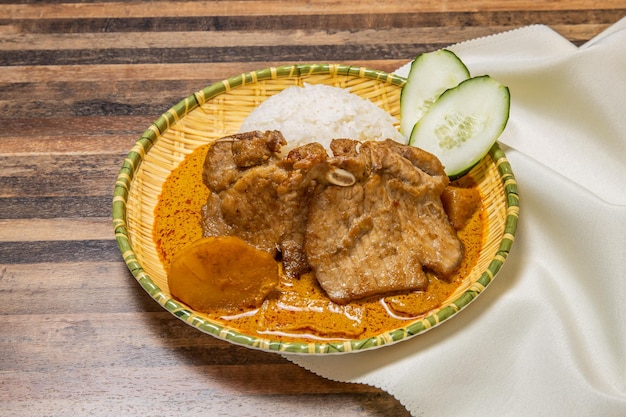 Pork chop curry with rice served in dish isolated on wooden table top view of hong kong fast food