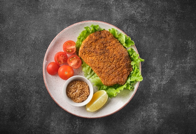 Pork cutlet with vegetables top view