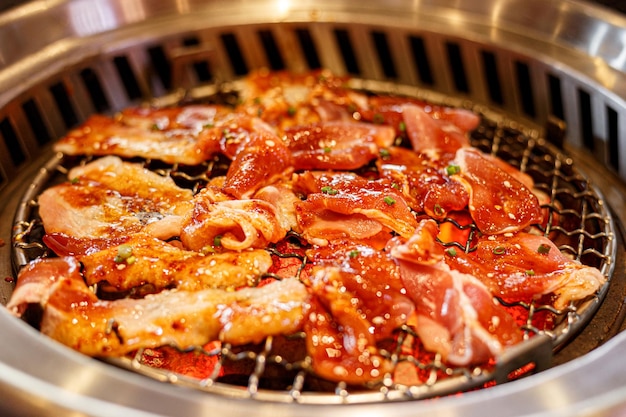 Pork on grilled over charcoal stove. Korean barbecue or yakiniku style