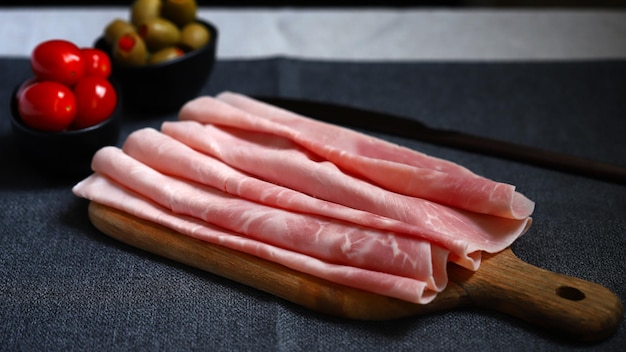 Pork ham slices on a wooden board