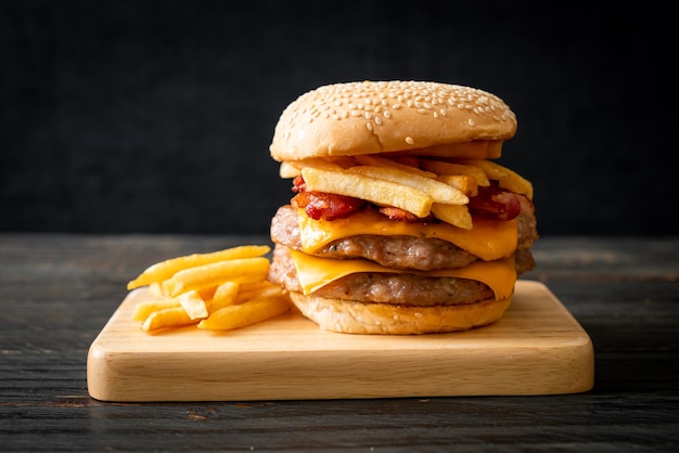 pork hamburger or pork burger with cheese, bacon and french fries