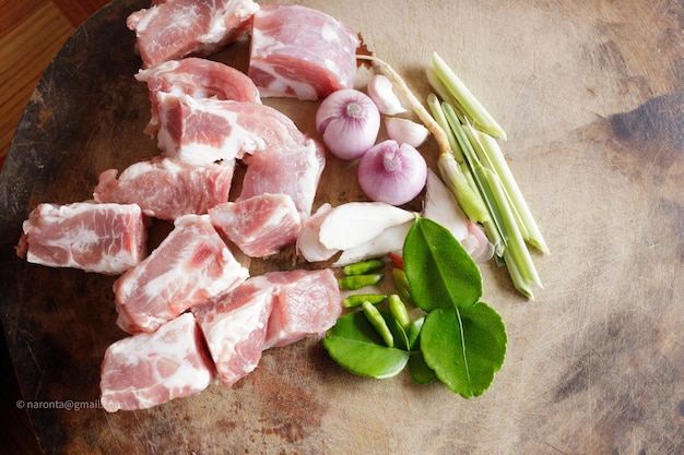 Pork and Herb Tom Yum put on a wooden chopping board