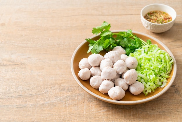 Pork meatball with vegetable and spicy sauce