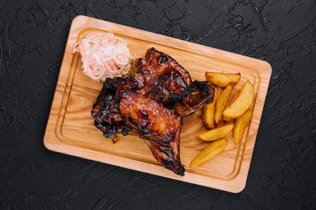 Pork ribs with baked potatoes and cabbage salad