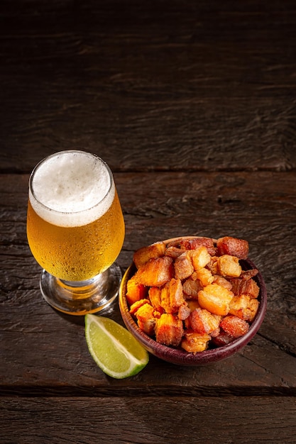 Pork rinds torresmo with beer typical Brazilian food