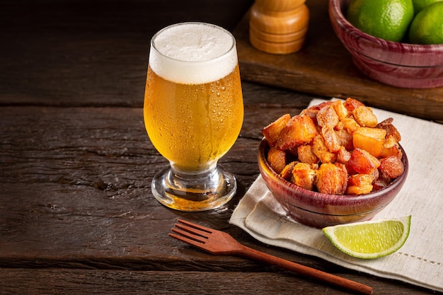 Pork rinds torresmo with beer typical Brazilian food