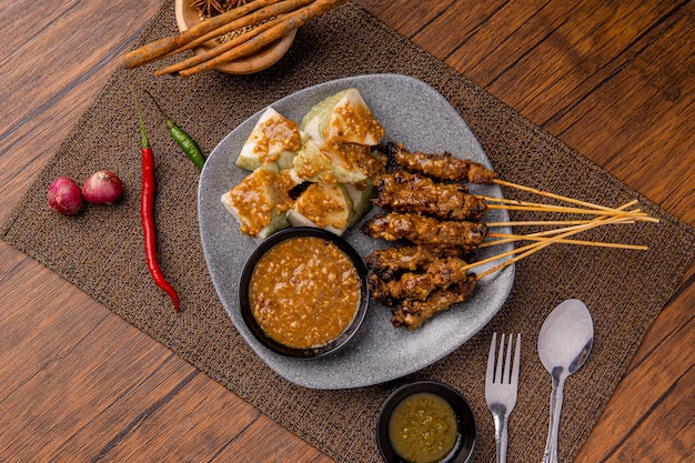 Pork Satay or Sate Babi Pork Satay served with a Peanut sauce and slices of lontong or ketupat rice cakes