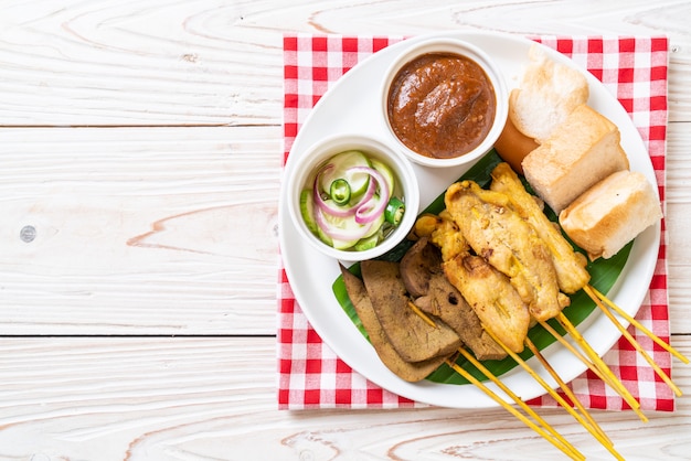 Pork satay with peanut sauce and pickles