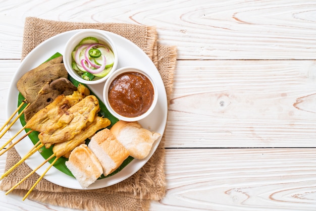 Pork satay with peanut sauce and pickles