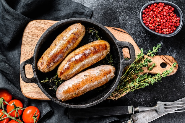 Pork sausages in a cast-iron pan