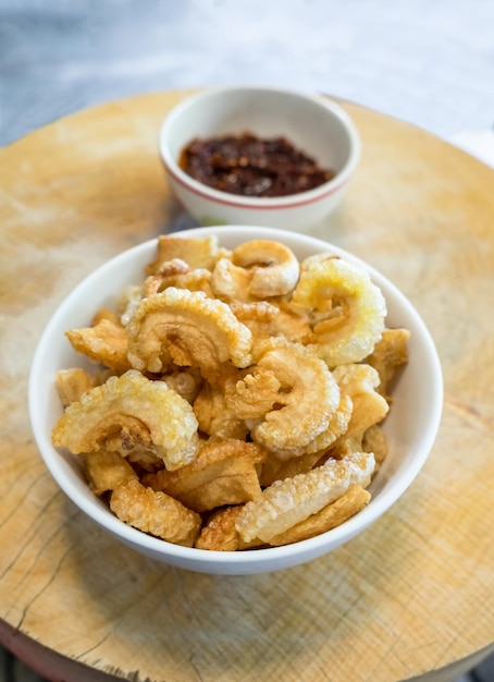 Pork snack pork rind in bowl with thai chili sauce