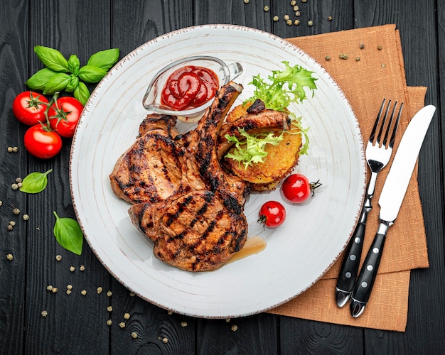 Pork steak with bone and potato pancakes