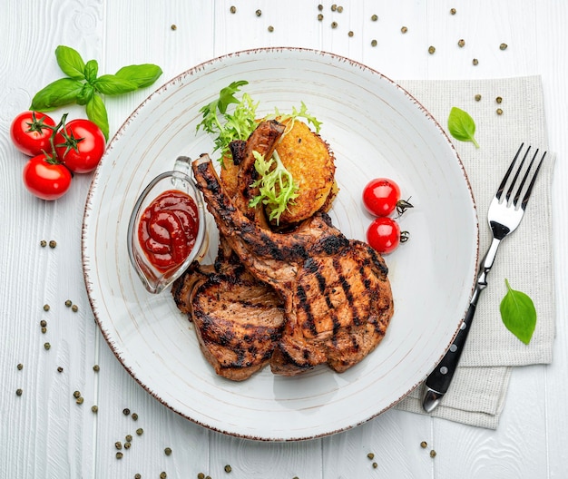 Pork steak with bone and potato pancakes