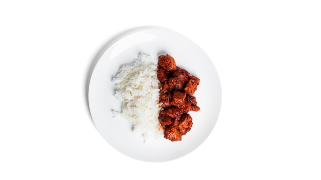 Pork stew with rice on white plate isolated on white. Goulash with rice. Rice with meat.